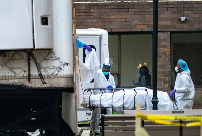 Kingsbrook Jewish Medical Center employees transport a deceased patient to a refrigerated truck in the Brooklyn borough of New York City. One of the city's hardest impacted hospitals due to the coronavirus (COVID-19), Kingsbrook has begun storing the bodies of the deceased in refrigerated trucks. (David Dee Delgado/Getty Images)