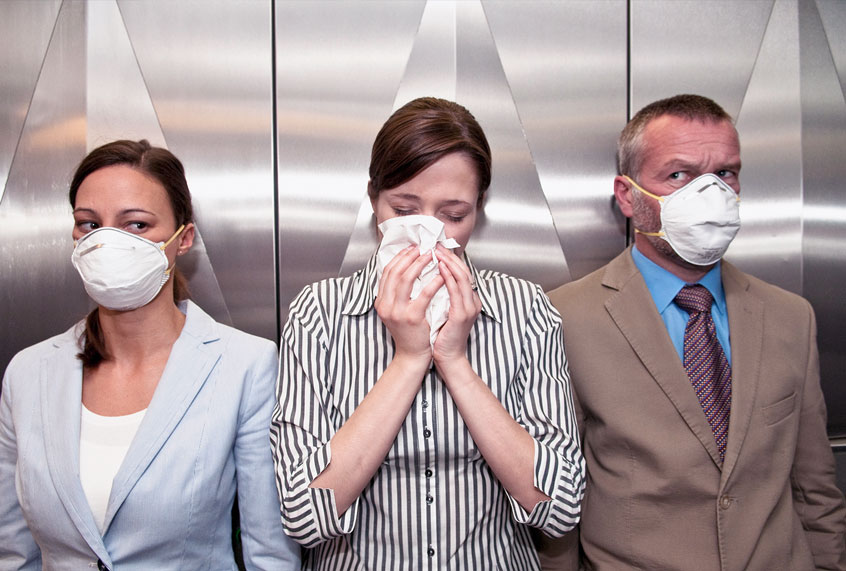 Woman coughing around others (Getty Images)