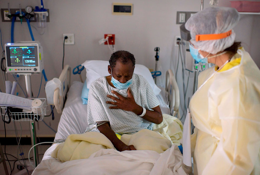 A healthcare worker tends to a patient in the Covid-19 Unit at United Memorial Medical Center in Houston, Texas on July 2, 2020. (MARK FELIX/AFP via Getty Images)