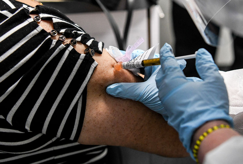 Sandra Rodriguez, 63, receives a COVID-19 vaccination from Yaquelin De La Cruz at the Research Centers of America (RCA) in Hollywood, Florida, on August 13, 2020. - So-called phase three vaccine clinical trials, in which thousands of people take part in the final stages, are gaining traction. (CHANDAN KHANNA/AFP via Getty Images)