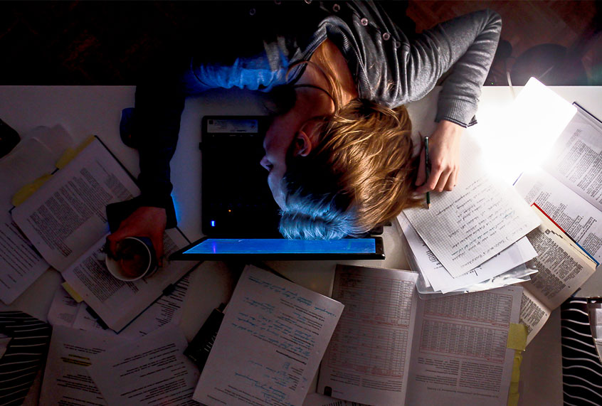 Tired, working woman sleeping on laptop late at night. (Getty Images)