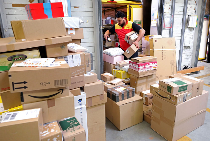 Parcels are sorted and distributed to the vehicles at a post office (Bernd Wüstneck/picture alliance via Getty Images)