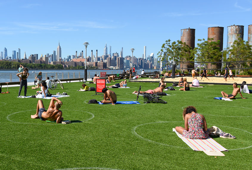 People practice social distancing in white circles in Domino Park in Williamsburg as the city continues Phase 4 of re-opening following restrictions imposed to slow the spread of coronavirus on August 20, 2020 in New York City. The fourth phase allows outdoor arts and entertainment, sporting events without fans and media production. (Noam Galai/Getty Images)