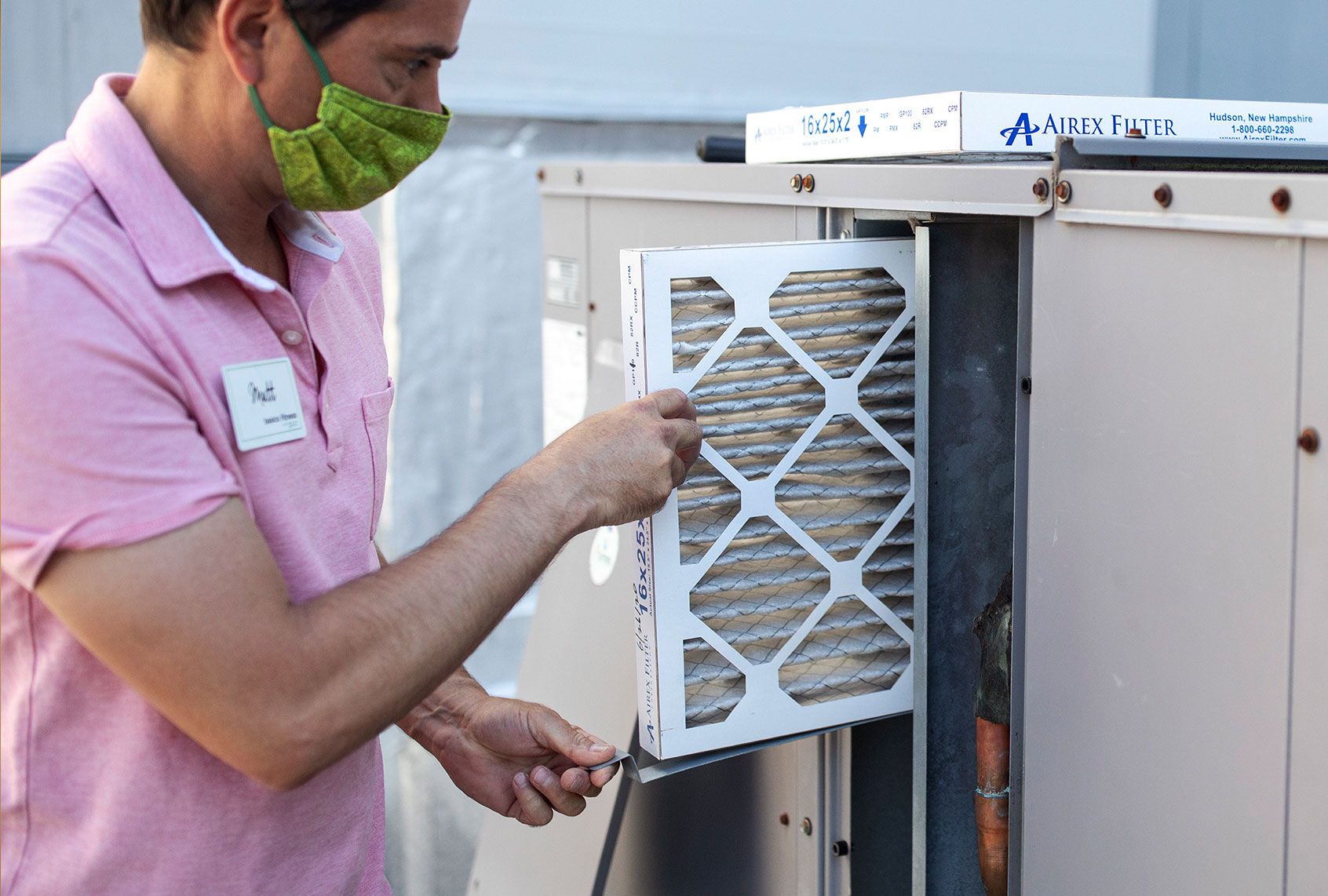 Mark Marston slides a MERV 13 air filtration filter back into the HVAC system outside of this gym Basics Fitness Center on Tuesday, July 21, 2020. (Brianna Soukup/Portland Press Herald via Getty Images)