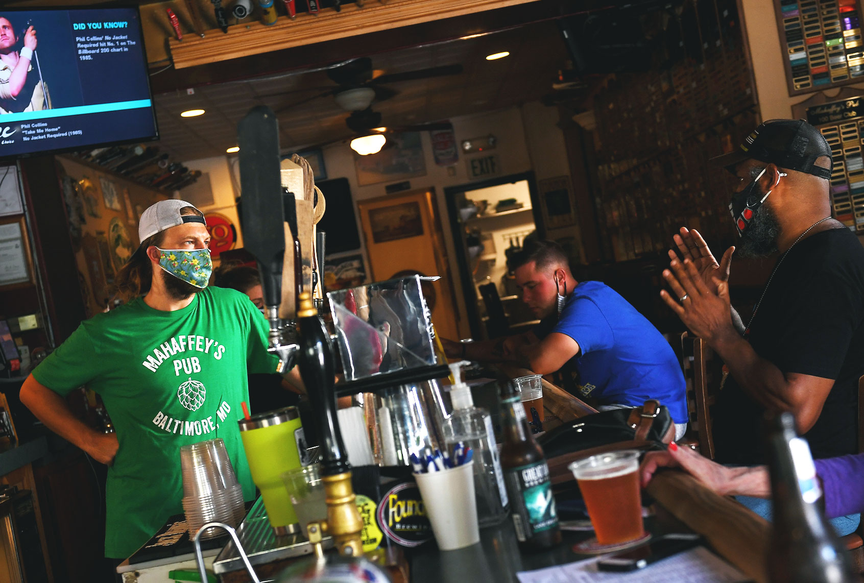 Dennis Kistner, owner of Mahaffreys Pub in Canton chats with customers from behind the bar July 23, 2020 in Baltimore, MD. With spikes in coronavirus infections, restaurants and bars in Baltimore have to close down indoor seating Friday. (Photo by (Katherine Frey/The Washington Post via Getty Images)
