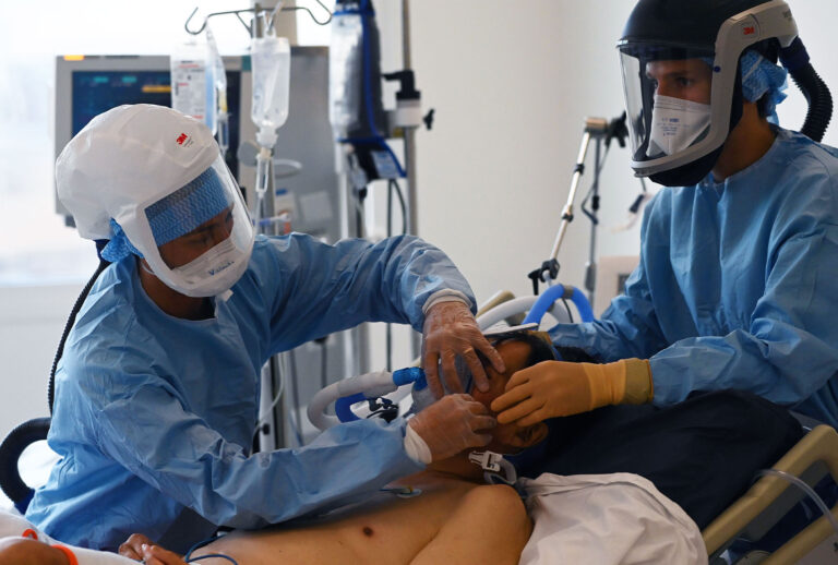 Medical staff take care of a patient suffering from Covid-19 at the emergency unit of La Timone hospital in Marseille, southeastern France, on September 11, 2020. (CHRISTOPHE SIMON/AFP via Getty Images)
