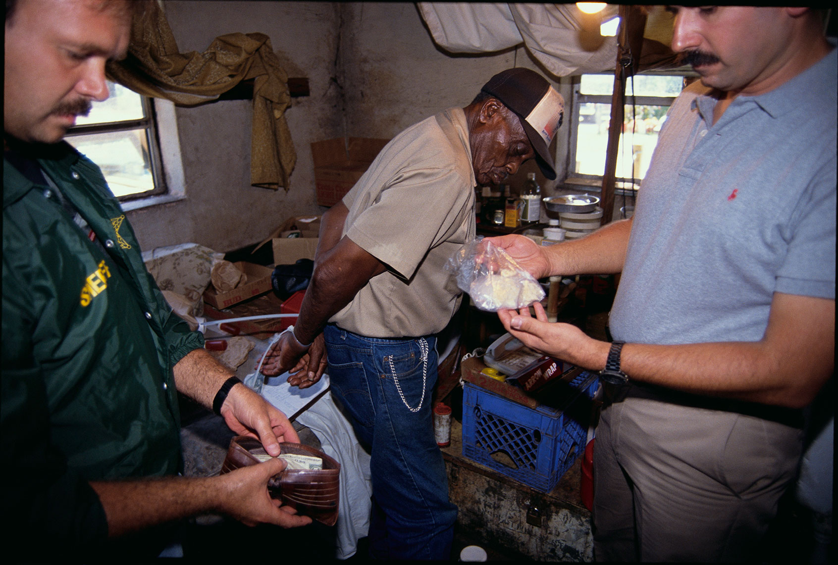 Law enforcement officers search through a crack house following a raid. (Steve Starr/CORBIS/Corbis via Getty Images)