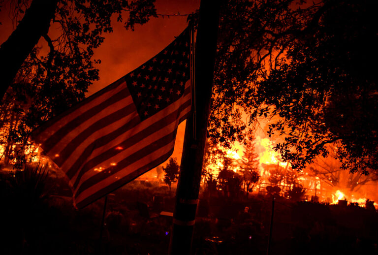Buildings burn along Highway 12 from the Shady Fire as it approaches Santa Rosa, California on September 28, 2020. - The wildfire quickly spread over the mountains and reached Santa Rosa where is has begun to affect homes. (SAMUEL CORUM/Agence France-Presse/AFP via Getty Images)