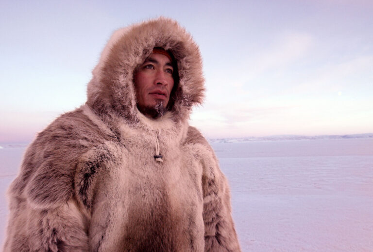 "The Last Ice": Inuit hunter Aleqatsiaq Peary looks out over sea ice near Qaanaaq, Greenland (National Geographic Society/Neil Gelinas)