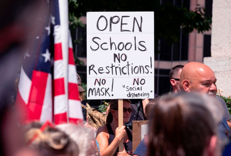 An anti-mask protestor holds up a sign in front of the Ohio Statehouse during a right-wing protest "Stand For America Against Terrorists and Tyrants" at State Capitol on July 18, 2020 in Columbus, Ohio. - Protestors descended on Columbus, Ohio for a planned anti-mask rally in response to local laws requiring people to wear a mask in many Ohio cities. (JEFF DEAN/AFP via Getty Images)