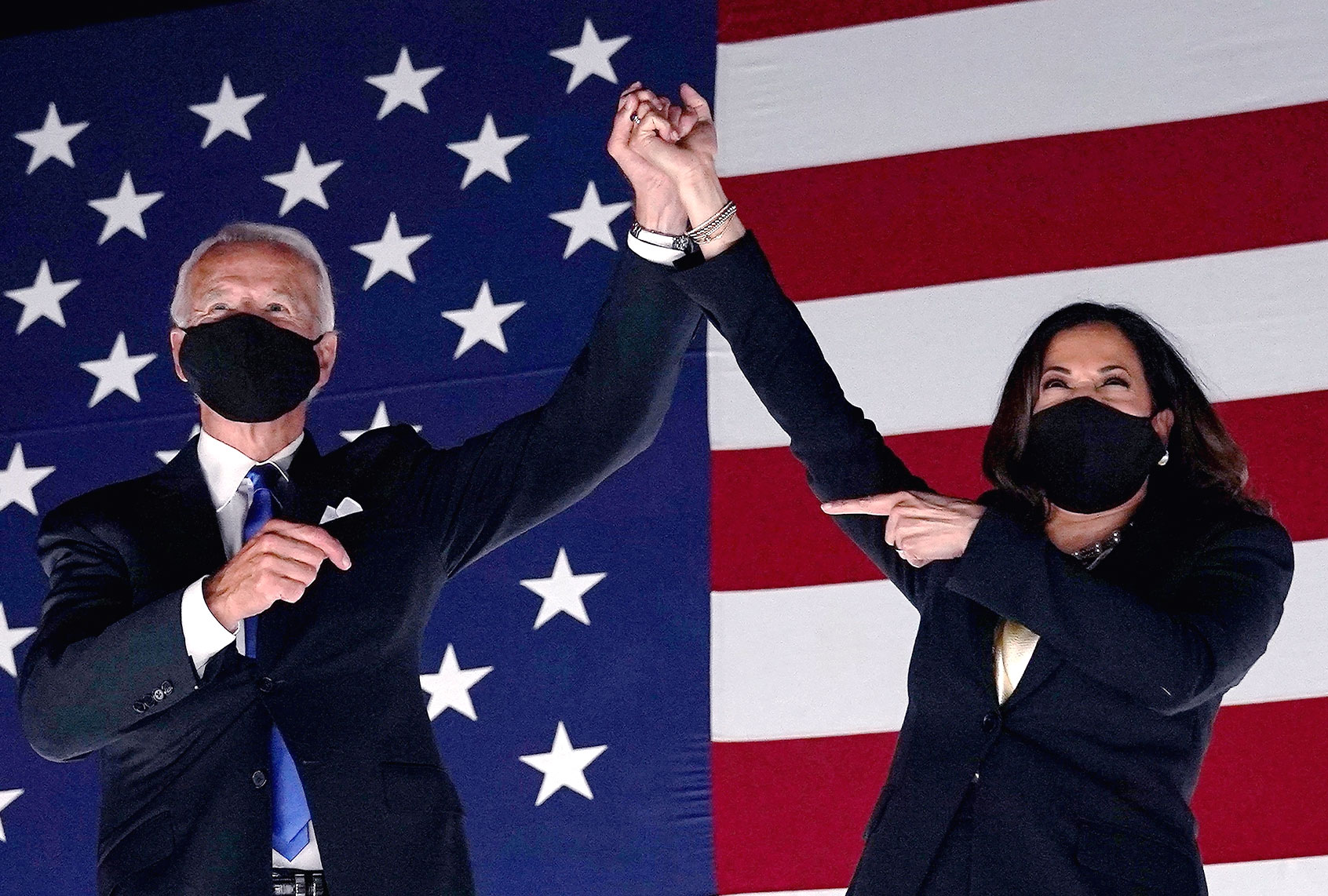 Former vice-president and Democratic presidential nominee Joe Biden (L) and Senator from California and Democratic vice presidential nominee Kamala Harris greet supporters outside the Chase Center in Wilmington, Delaware, at the conclusion of the Democratic National Convention, held virtually amid the novel coronavirus pandemic, on August 20, 2020. (OLIVIER DOULIERY/AFP via Getty Images)
