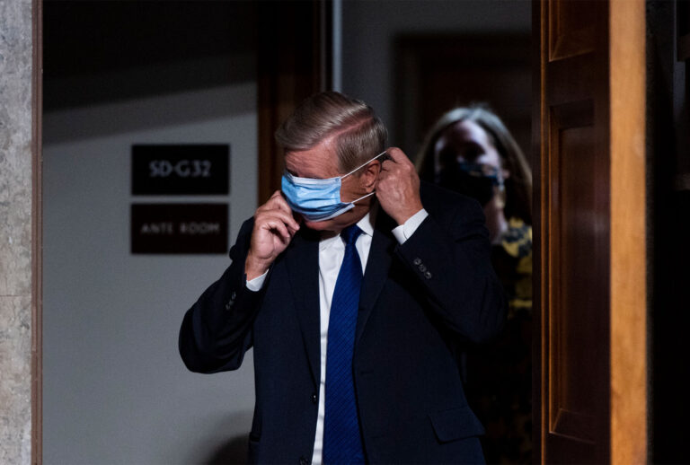 Chairman Sen. Lindsey Graham, (R-SC), puts on his face mask as he arrives for a Senate Judiciary Committee hearing. (Bill Clark-Pool/Getty Images)