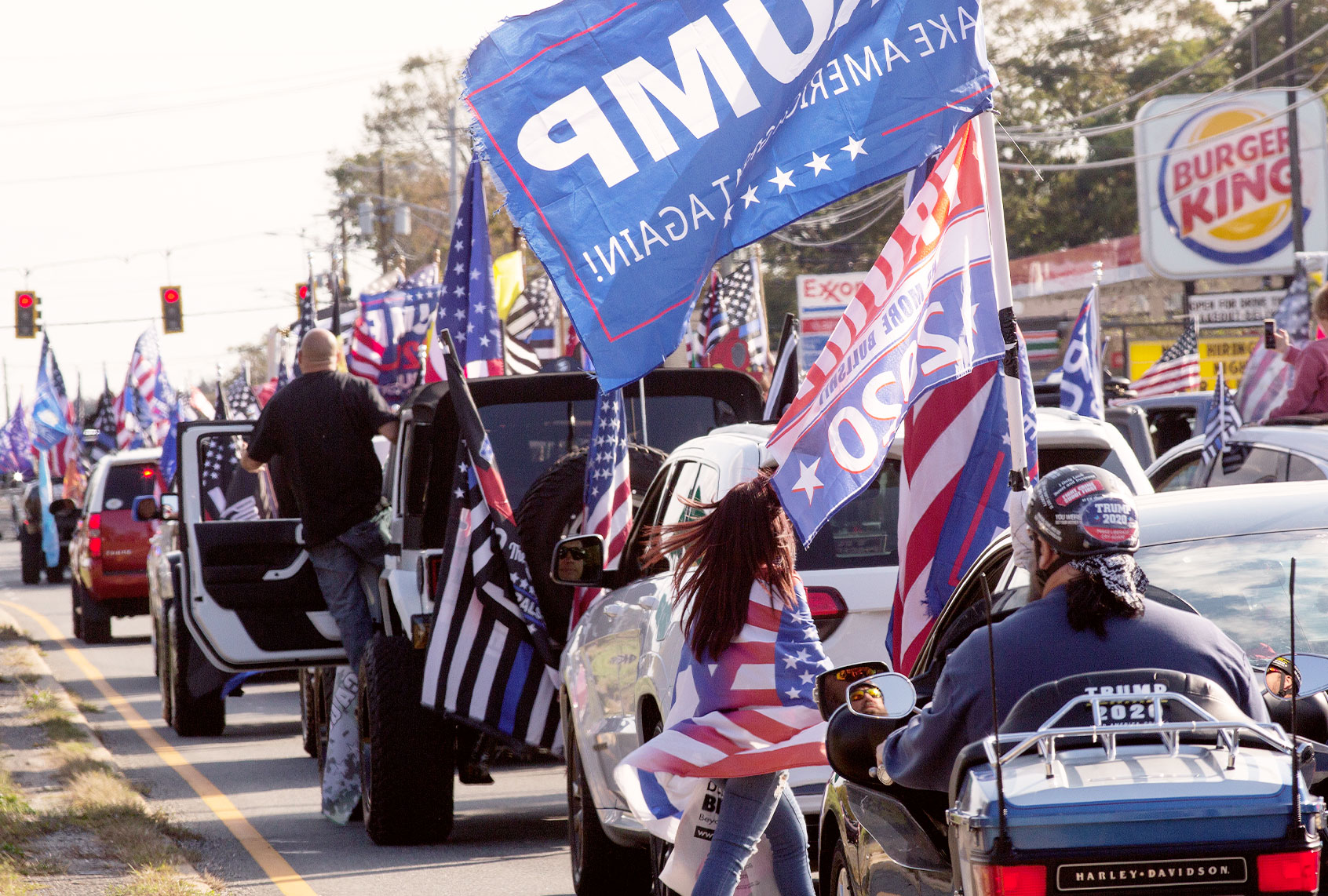 Trump supporters gather in a Long Island Rail Road parking lot before driving in cars as part of a caravan on October 18, 2020 in Seaford, New York. The group Long Island Loud Majority organized a car caravan ride from Seaford to Montauk to show their support for President Trump and his reelection in November. (Andrew Lichtenstein/Corbis via Getty Images)