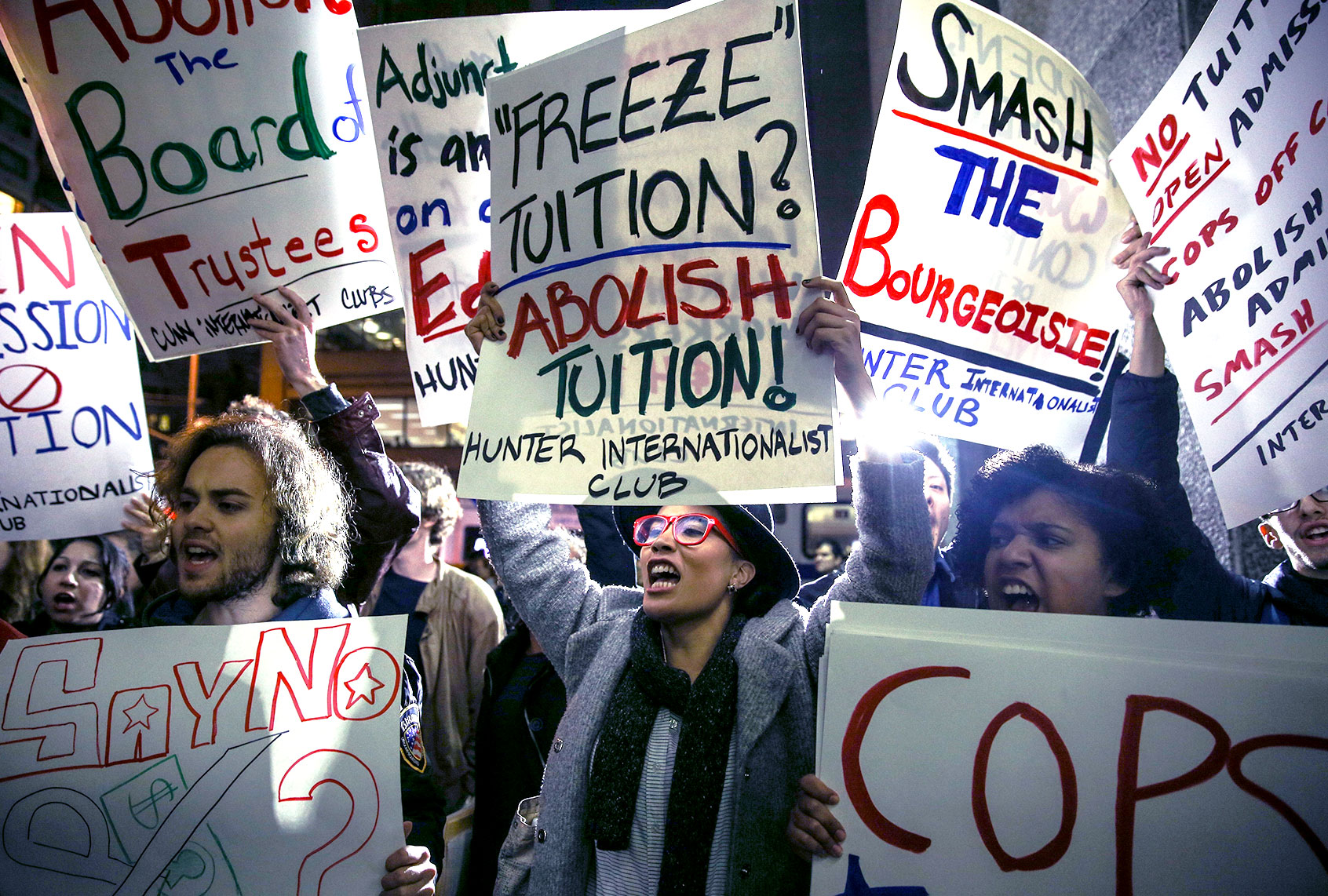 Students hold placards as they stage a demonstration at the Hunter College, which is a part of New York City University, to protest ballooning student loan debt for higher education and rally for tuition-free public colleges in New York on November 13, 2015. (Cem Ozdel/Anadolu Agency/Getty Images)