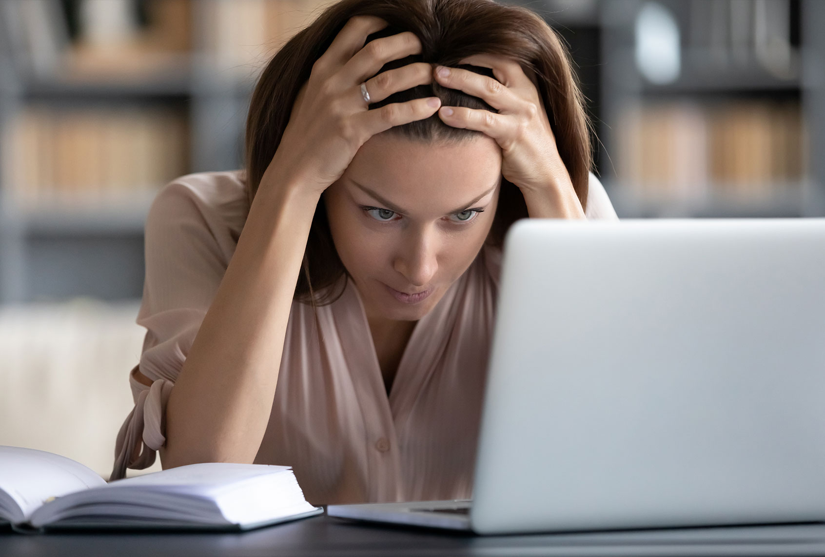 Woman glaring at laptop (Getty Images)