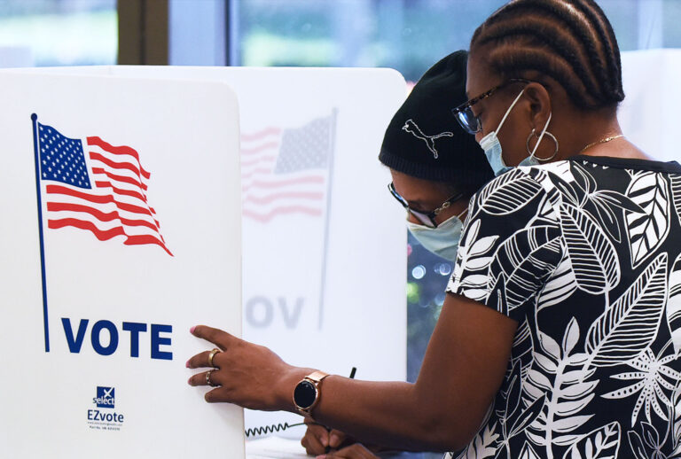 Women wearing face masks fill out vote-by-mail ballots at the Orange County Supervisor of Elections office on October 15, 2020 in Orlando, Florida. (Paul Hennessy/NurPhoto via Getty Images)