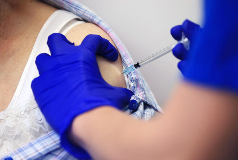 Nurse Practitioner Terri Welch administers a dose of the Pfizer-BioNTech Covid-19 vaccine to a patient at the Haxby and Wigginton Group Medical Practice in Haxby, northern England on December 22, 2020. (LINDSEY PARNABY/AFP via Getty Images)