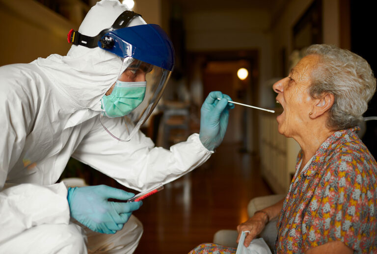 Doing a COVID test in full PPE wear at a senior's home (Getty Images)