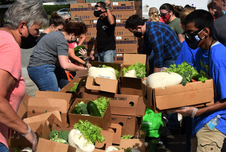 Volunteers distribute turkeys and other food assistance to the needy at a food distribution site at Lake-Sumter State College sponsored by the Second Harvest Food Bank of Central Florida and local churches (Paul Hennessy/SOPA Images/LightRocket via Getty Images)