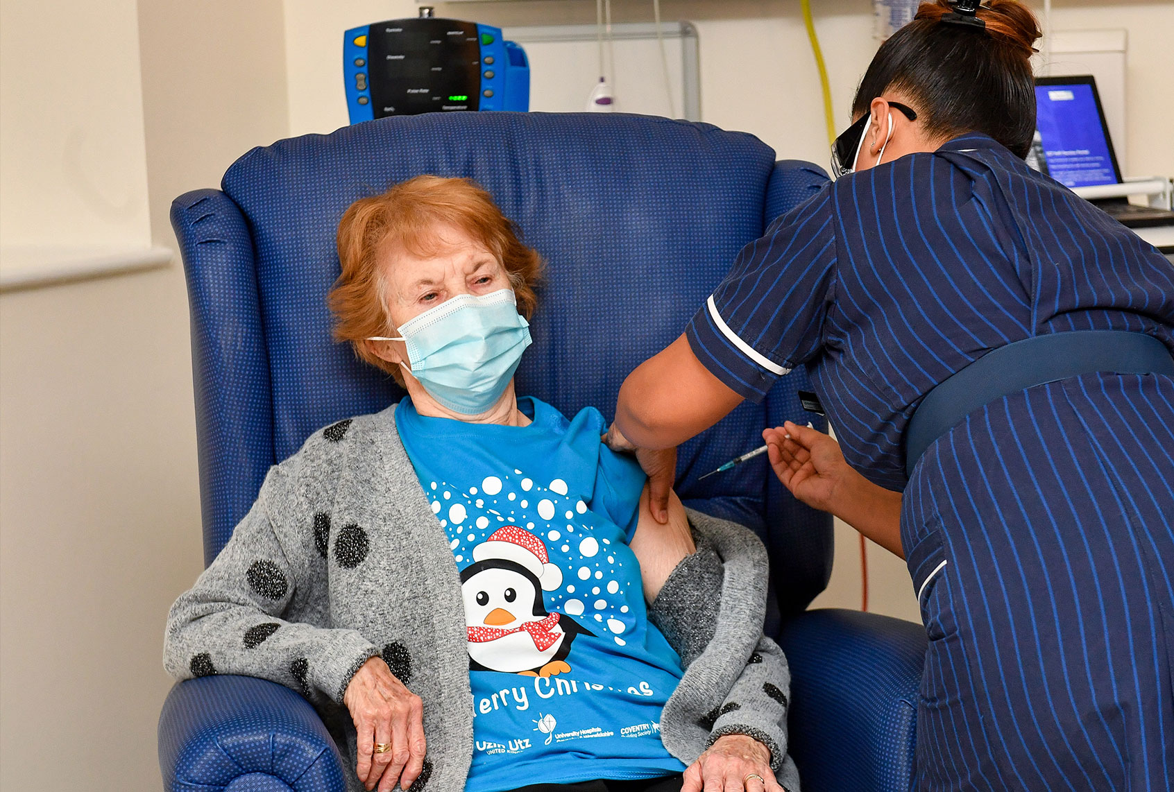 Margaret Keenan, 90, is the first patient in the United Kingdom to receive the Pfizer/BioNtech covid-19 vaccine at University Hospital, Coventry, administered by nurse May Parsons, at the start of the largest ever immunization program in the UK's history on December 8, 2020 in Coventry, United Kingdom. (Jacob King - Pool / Getty Images)