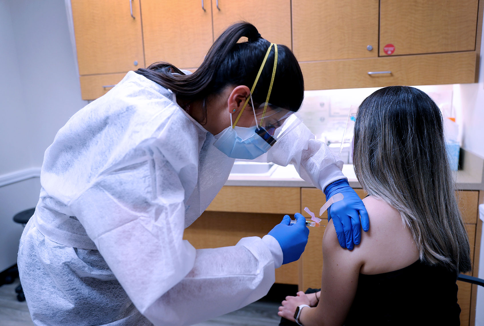 Nurse Practitioner wears personal protection equipment as she administers a flu vaccination (Getty Images)