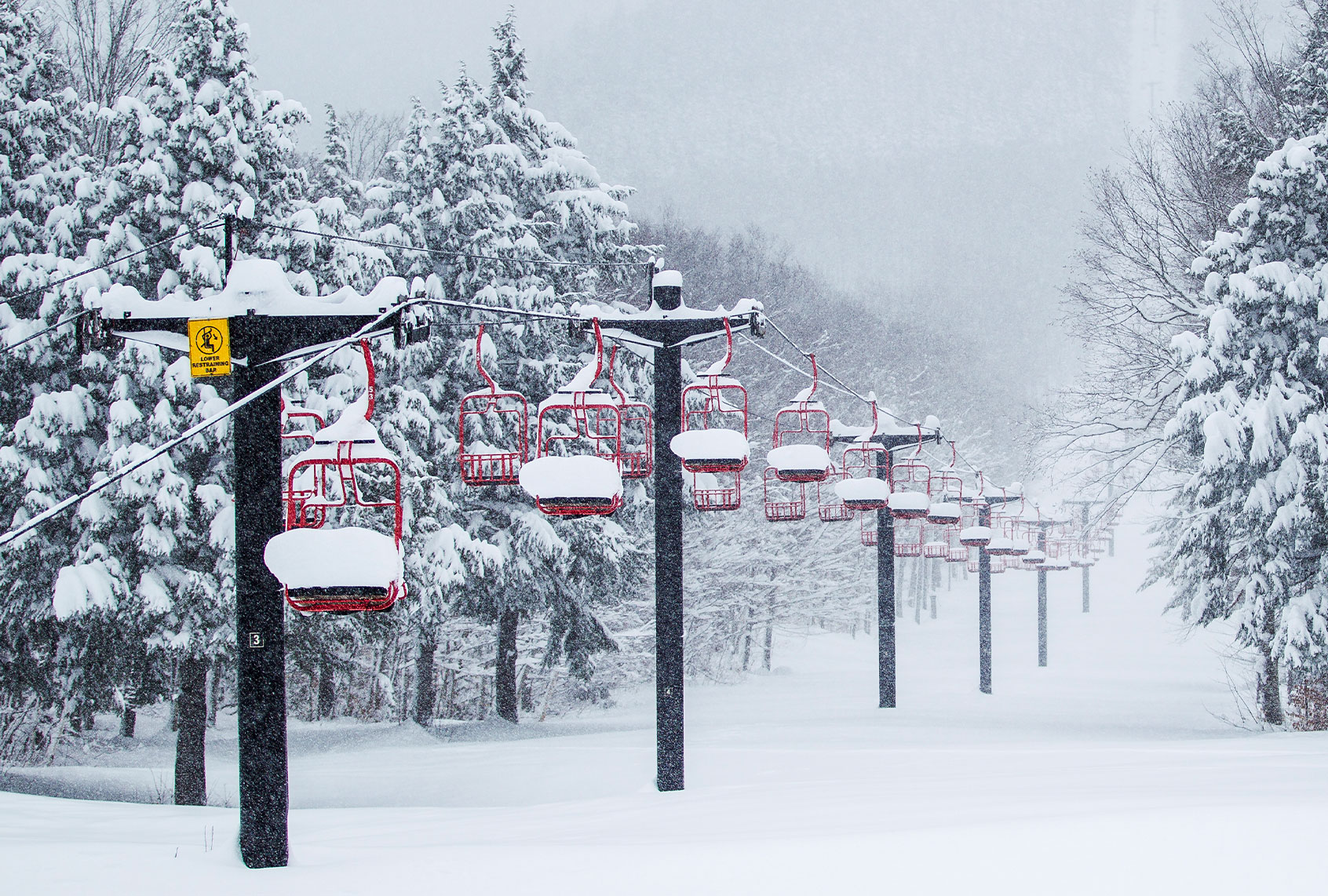 Ski lift filled with fresh powder snow during a snow storm (Getty Images)
