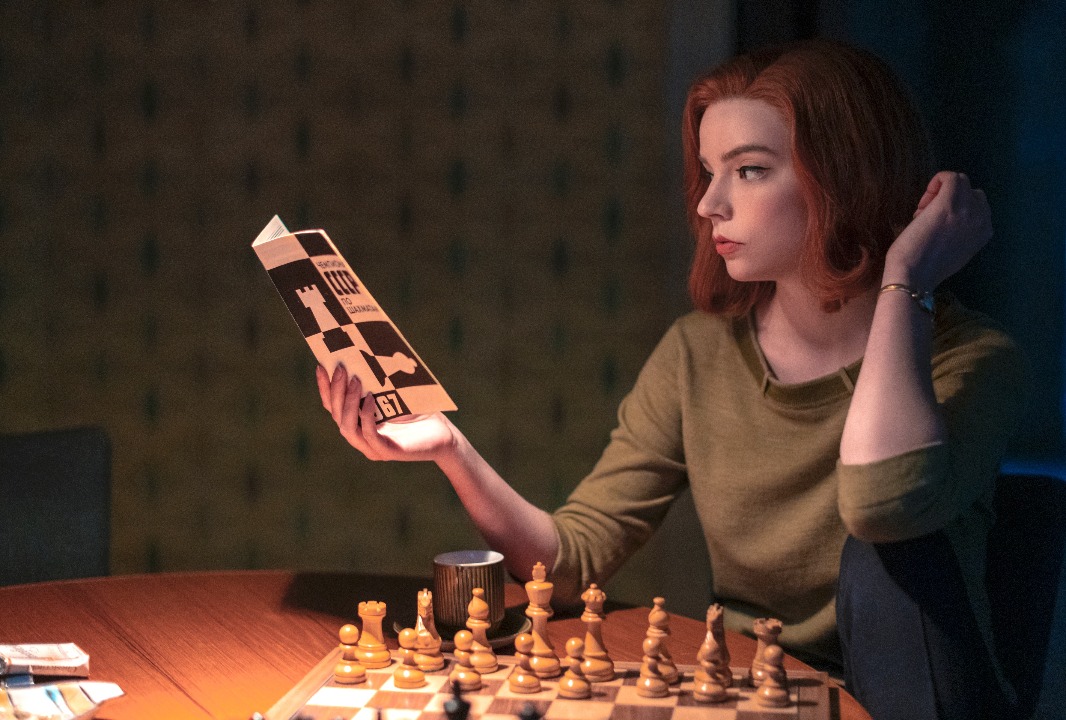 Anya Taylor-Joy as Beth Harmon, reading a chess book in "The Queen's Gambit" (Netflix)