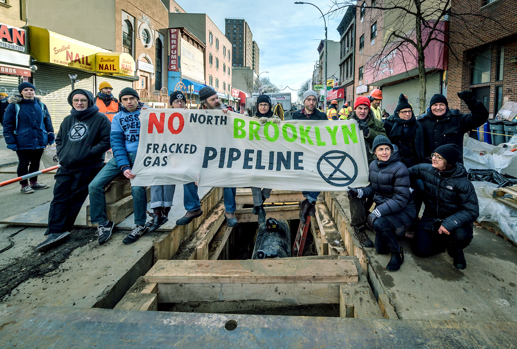 Protesters holding a banner during the construction blockade. 10 people from the climate activist group Extinction Rebellion NYC (XRNYC) were arrested in Bushwick for blocking the construction of the North Brooklyn fracked gas transmission pipeline for over 2 hours in a non-violent civil disobedience protest of this massive fossil fuel project. (Erik McGregor/LightRocket via Getty Images)