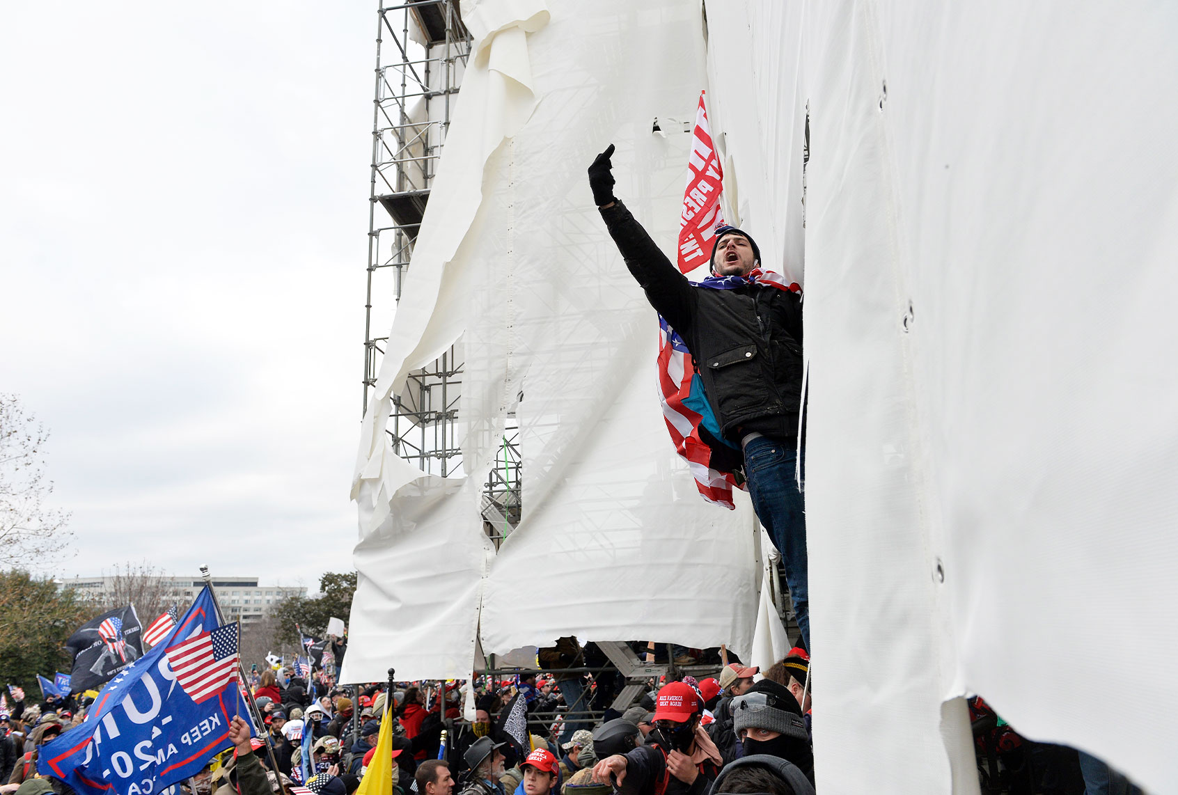 A Trump supporter climbs scaffolding during the June 6 Capitol riot (Joseph Prezioso / AFP via Getty Images)