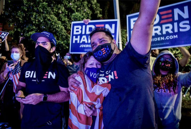 Supporters get emotional as they watch US President-elect Joe Biden and Vice President-elect Kamala Harris deliver remarks, in Miami on November 7, 2020, after they were declared the winners of the presidential election. (CHANDAN KHANNA/AFP via Getty Images)
