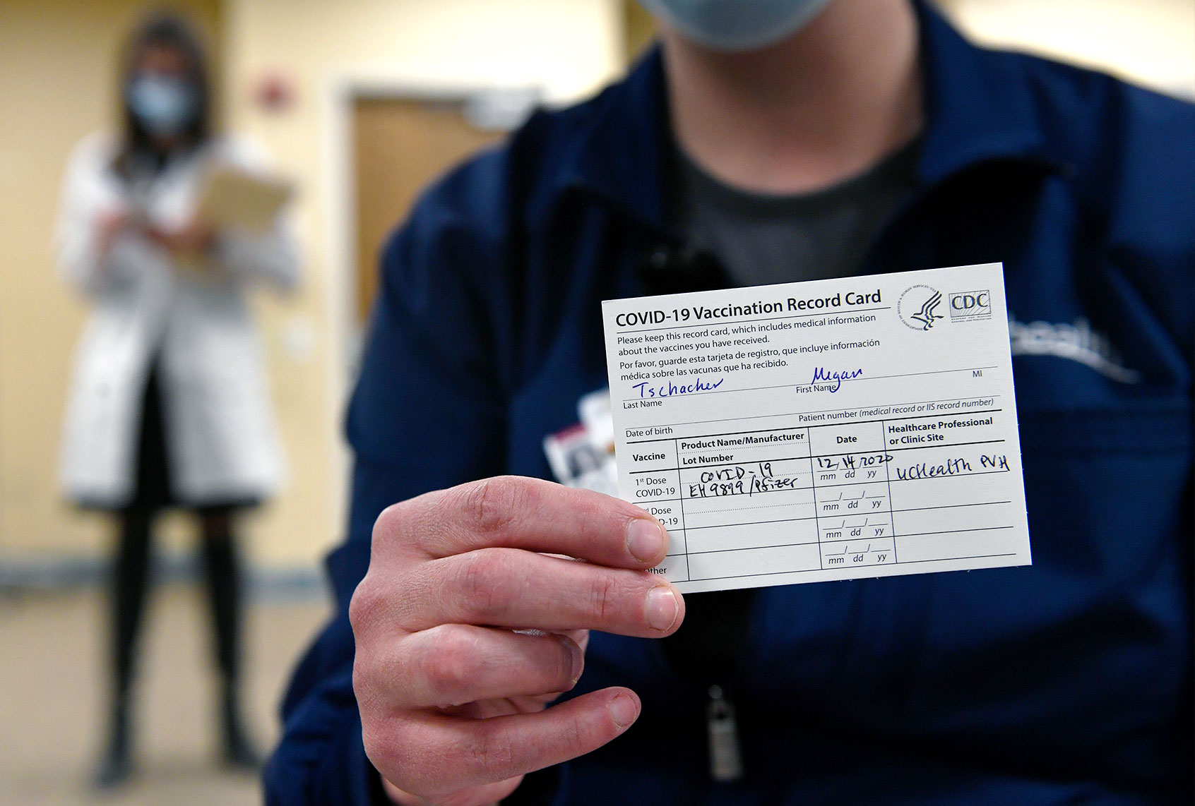 Poudre Valley Hospital ICU Nurse Megan Tschacher shows off her vaccination card after getting the first round of Covid-19 vaccines at UC Health Poudre Valley Hospital on December 14, 2020 in Fort Collins, Colorado. The first Covid-19 vaccines were administered in Colorado to frontline health care workers in Fort Collins and Colorado Springs today. (Helen H. Richardson/MediaNews Group/The Denver Post via Getty Images)