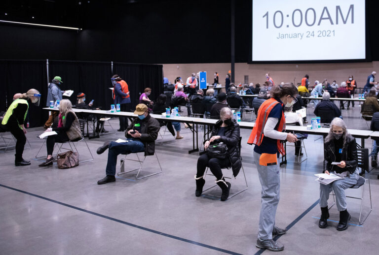 Patients wait and are observed for an adverse reactions following their first dose of the Covid-19 vaccine at the Amazon Meeting Center in downtown Seattle, Washington on January 24, 2021. - Amazon is partnering with Virginia Mason for a one-day pop-up clinic on January 24. 2021 that aims to vaccinate 2,000 people at the companys Meeting Center near downtown Seattle. Virginia Mason is handling vaccine administration, while Amazon is providing the location and help with logistics. (GRANT HINDSLEY/AFP via Getty Images)