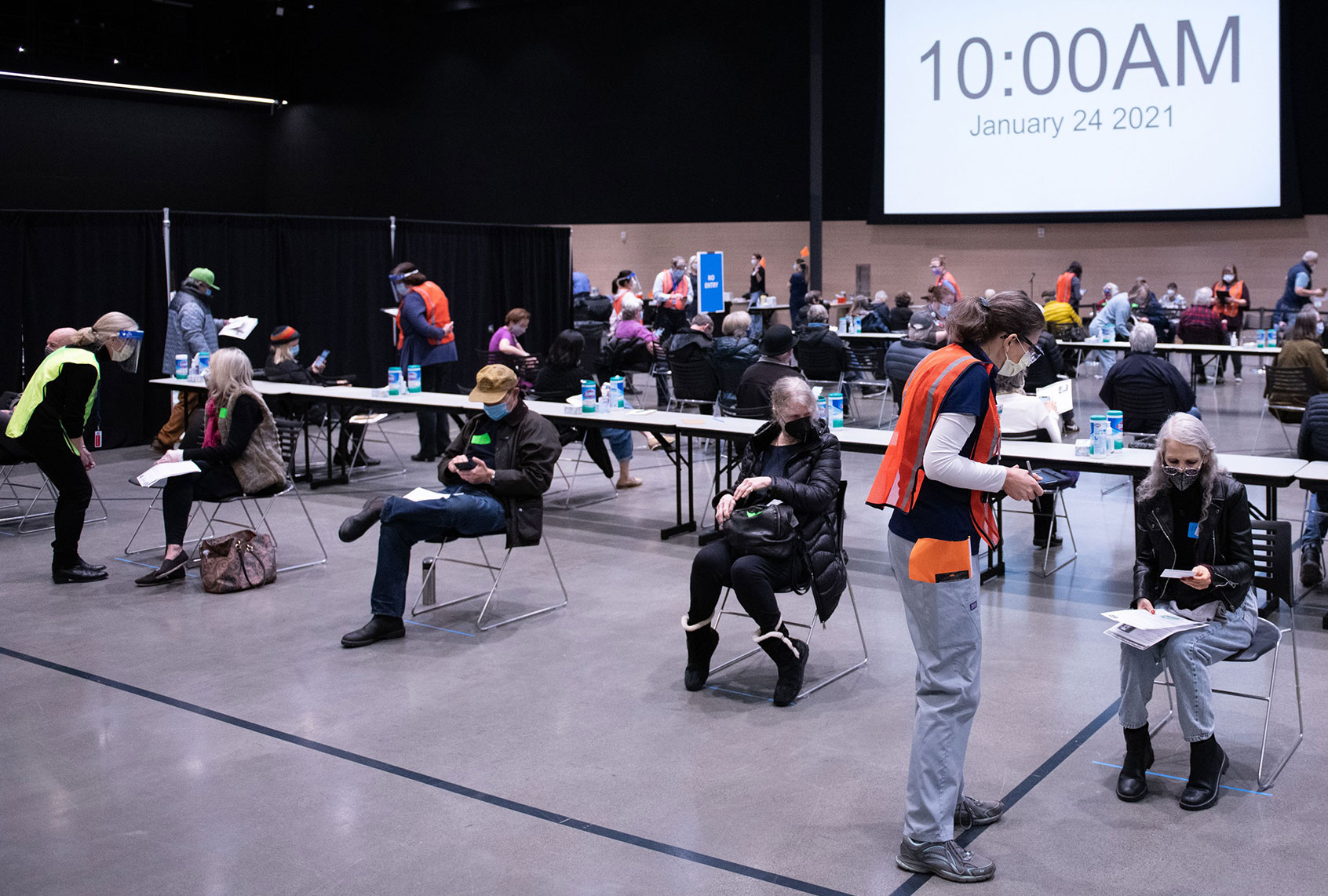 Patients wait and are observed for an adverse reactions following their first dose of the Covid-19 vaccine at the Amazon Meeting Center in downtown Seattle, Washington on January 24, 2021. - Amazon is partnering with Virginia Mason for a one-day pop-up clinic on January 24. 2021 that aims to vaccinate 2,000 people at the companys Meeting Center near downtown Seattle. Virginia Mason is handling vaccine administration, while Amazon is providing the location and help with logistics. (GRANT HINDSLEY/AFP via Getty Images)