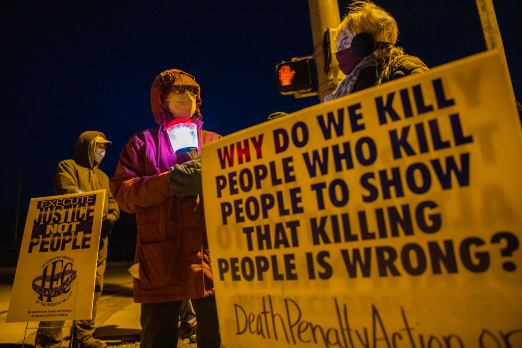Indiana anti-death-penalty activist Glenda Breeden holds a lamp while protesting against the execution of Lisa Montgomery and two others, which are scheduled at Terre Haute Federal Prison this week. (Jeremy Hogan/SOPA Images/LightRocket via Getty Images)