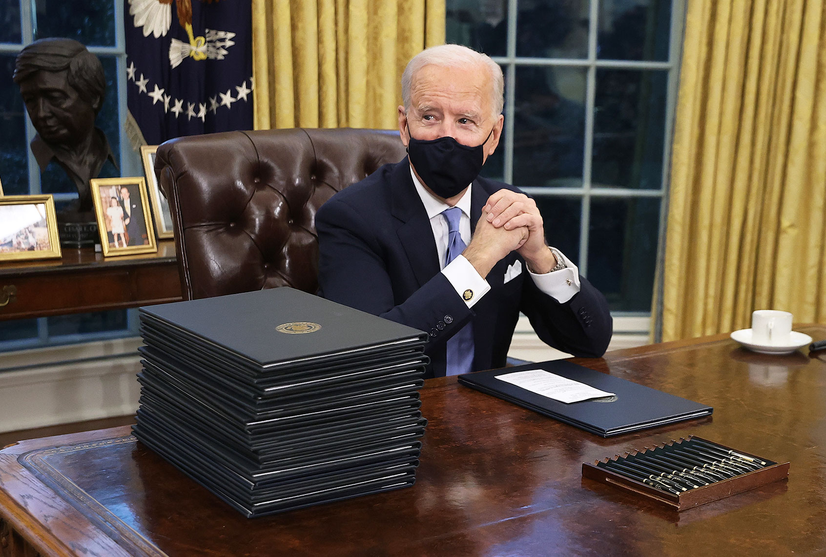 U.S. President Joe Biden prepares to sign a series of executive orders at the Resolute Desk in the Oval Office just hours after his inauguration on January 20, 2021 in Washington, DC. Biden became the 46th president of the United States earlier today during the ceremony at the U.S. Capitol. (Chip Somodevilla/Getty Images)