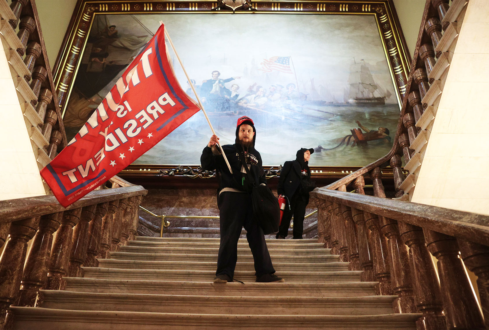 A protester holds a Trump flag inside the US Capitol Building near the Senate Chamber on January 06, 2021 in Washington, DC. Congress held a joint session today to ratify President-elect Joe Biden's 306-232 Electoral College win over President Donald Trump. A group of Republican senators said they would reject the Electoral College votes of several states unless Congress appointed a commission to audit the election results. (Win McNamee/Getty Images)