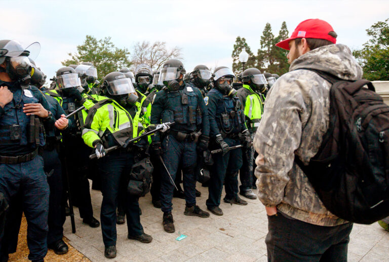 Trump supporters face off with police and security forces in front of the US Capitol in Washington DC on January 6, 2021. - Donald Trump's supporters stormed a session of Congress held today, January 6, to certify Joe Biden's election win, triggering unprecedented chaos and violence at the heart of American democracy and accusations the president was attempting a coup. (ANDREW CABALLERO-REYNOLDS/AFP via Getty Images)