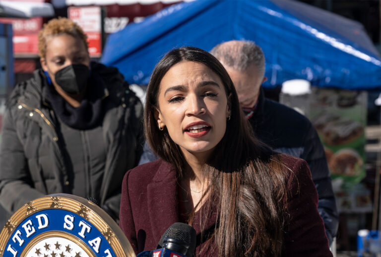 U. S. Representative Alexandria Ocasio-Cortez speaks during joint announcement with U. S. Senator Chuck Schumer at 103rd Street Corona Plaza. Schumer and Ocasio-Cortez announced that in recent COVID relief legislation, the Federal Emergency Management Administration will help pay for the funeral and burial of COVID-hit families that cannot afford it via a $2 billion national pot of disaster funds out of which $260 million will be allocated to New York City. (Lev Radin/Pacific Press/LightRocket via Getty Images)