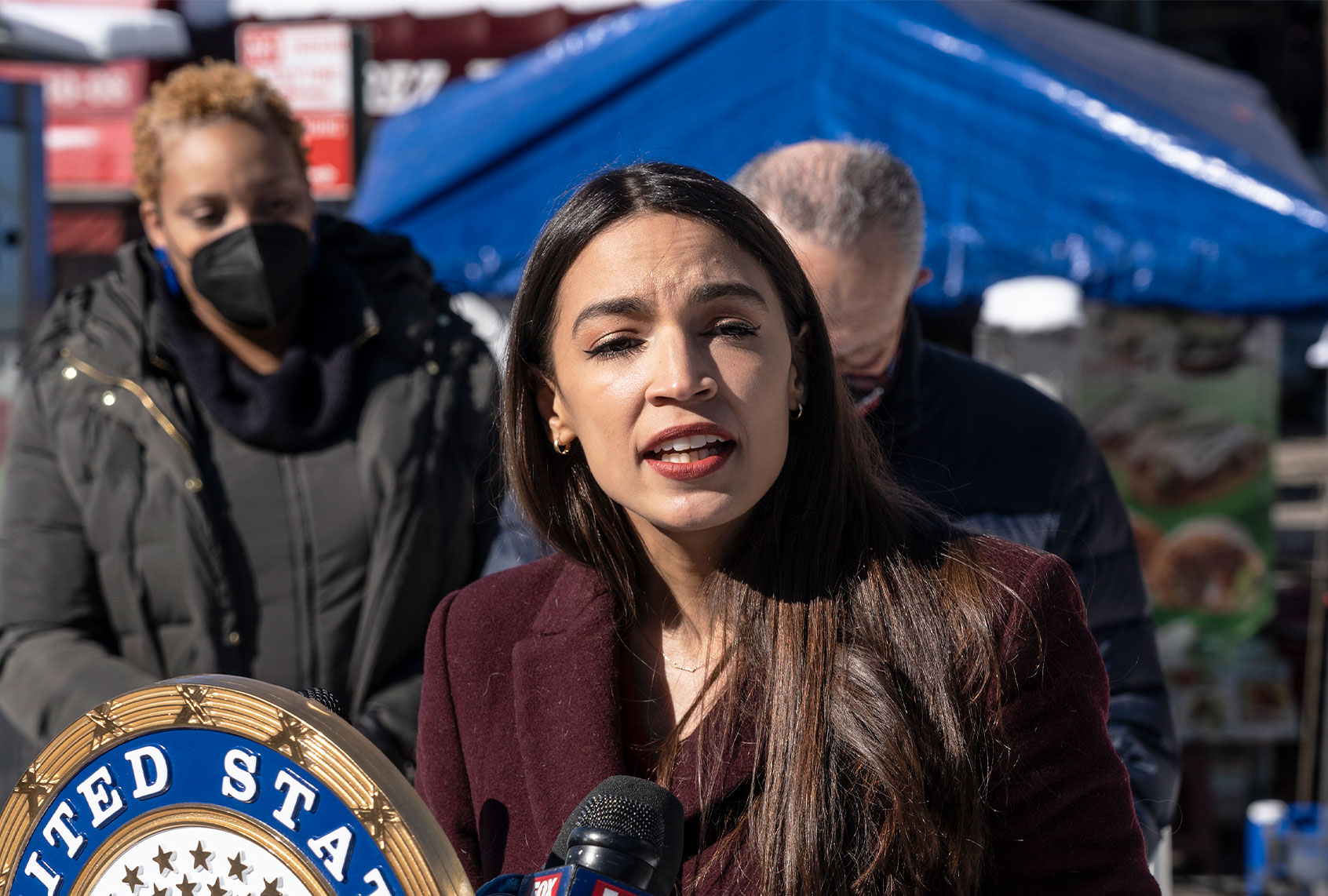 U. S. Representative Alexandria Ocasio-Cortez speaks during joint announcement with U. S. Senator Chuck Schumer at 103rd Street Corona Plaza. Schumer and Ocasio-Cortez announced that in recent COVID relief legislation, the Federal Emergency Management Administration will help pay for the funeral and burial of COVID-hit families that cannot afford it via a $2 billion national pot of disaster funds out of which $260 million will be allocated to New York City. (Lev Radin/Pacific Press/LightRocket via Getty Images)
