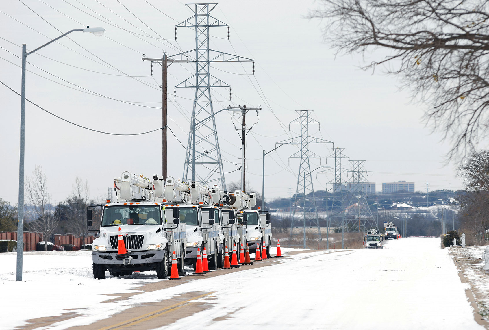 Pike Electric service trucks line up after a snow storm on February 16, 2021 in Fort Worth, Texas. Winter storm Uri has brought historic cold weather and power outages to Texas as storms have swept across 26 states with a mix of freezing temperatures and precipitation. (Ron Jenkins/Getty Images)