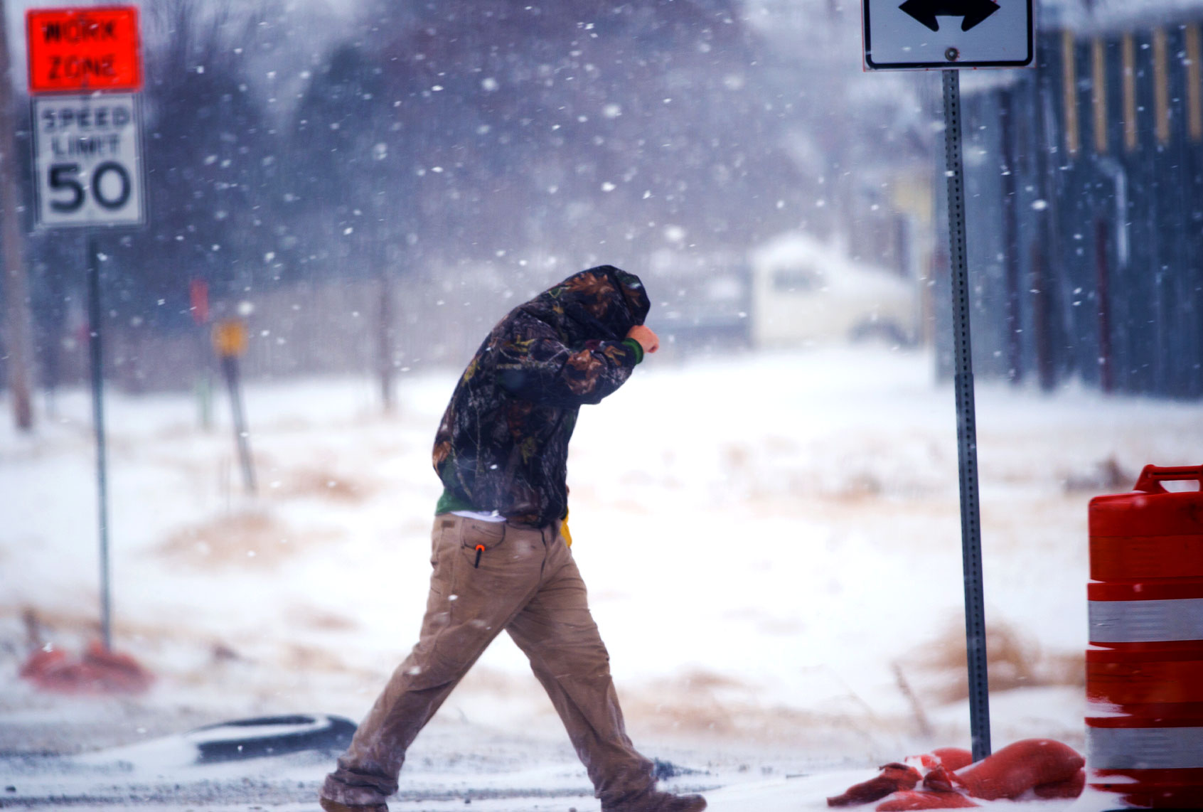 A highway worker tries to shield himself while walking to his truck in Lubbock, Texas. (John Weast/Getty Images)