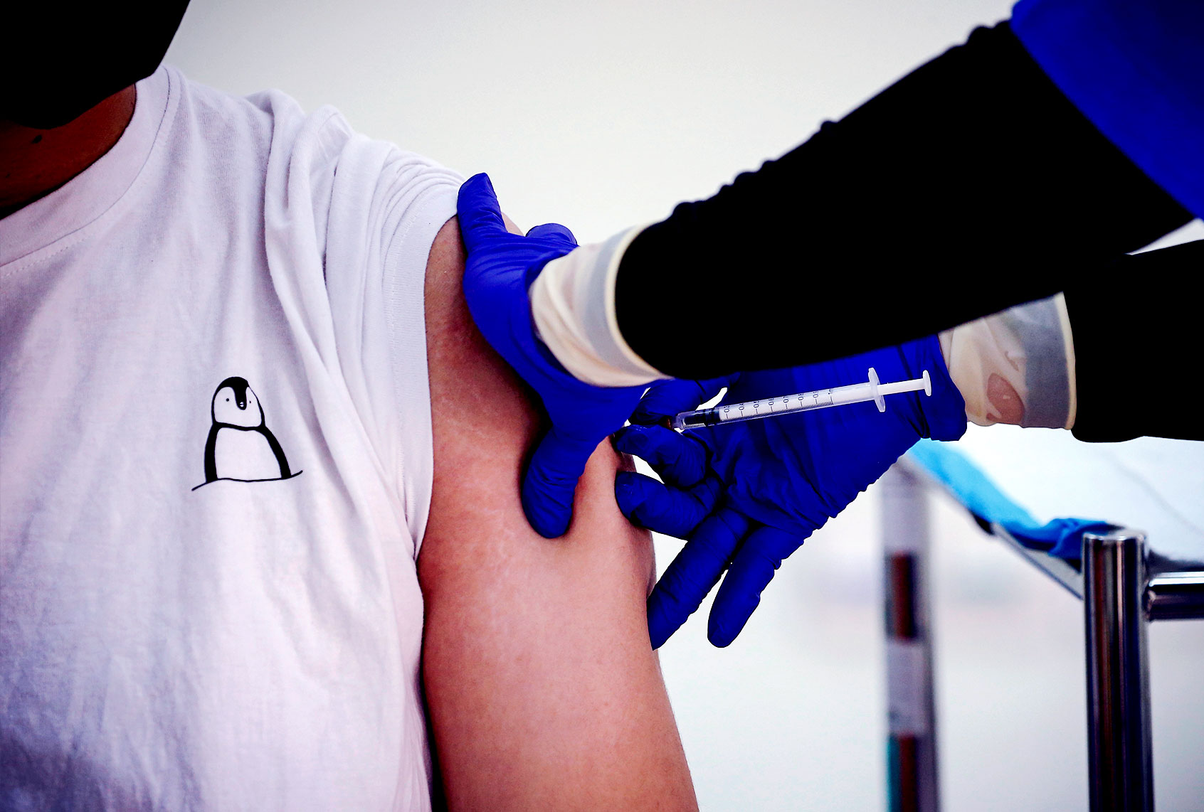 A healthcare worker receives a dose of Pfizer-BioNTech Covid-19 vaccine (Wong Fok Loy/SOPA Images/LightRocket via Getty Images)