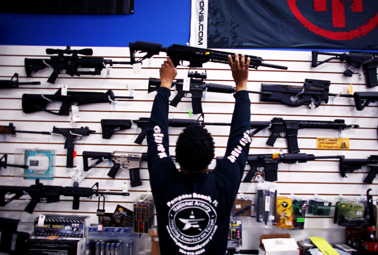 An employee puts a weapon on display at the National Armory gun store on April 11, 2013 in Pompano Beach, Florida. (Joe Raedle/Getty Images)