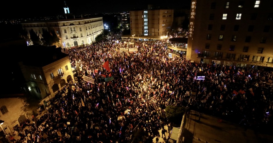 Tens of thousands of people gather in front of the Israeli Parliament during a pre-election demonstration to protest against Israeli Prime Minister Benjamin Netanyahu, in West Jerusalem on March 20, 2021. (Mostafa Alkharouf/Anadolu Agency via Getty Images)