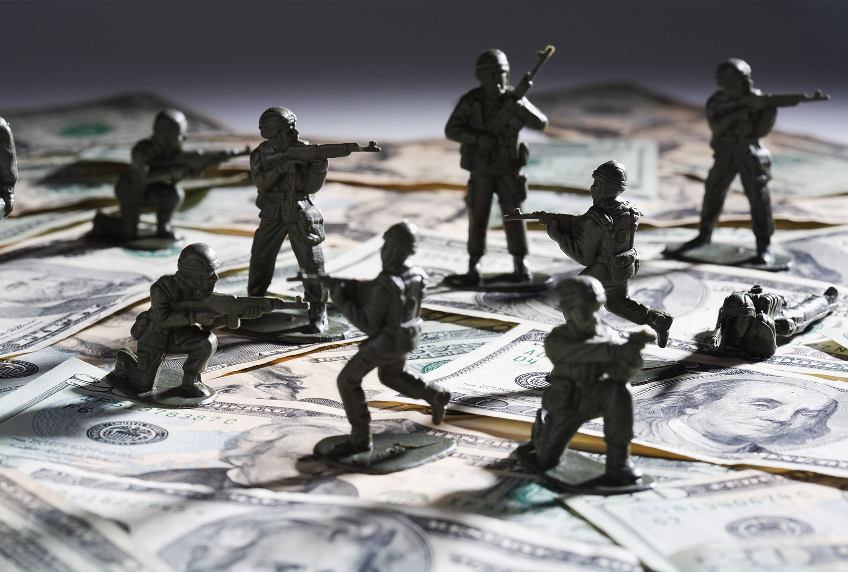 Toy soldier fighting on money (Getty Images)