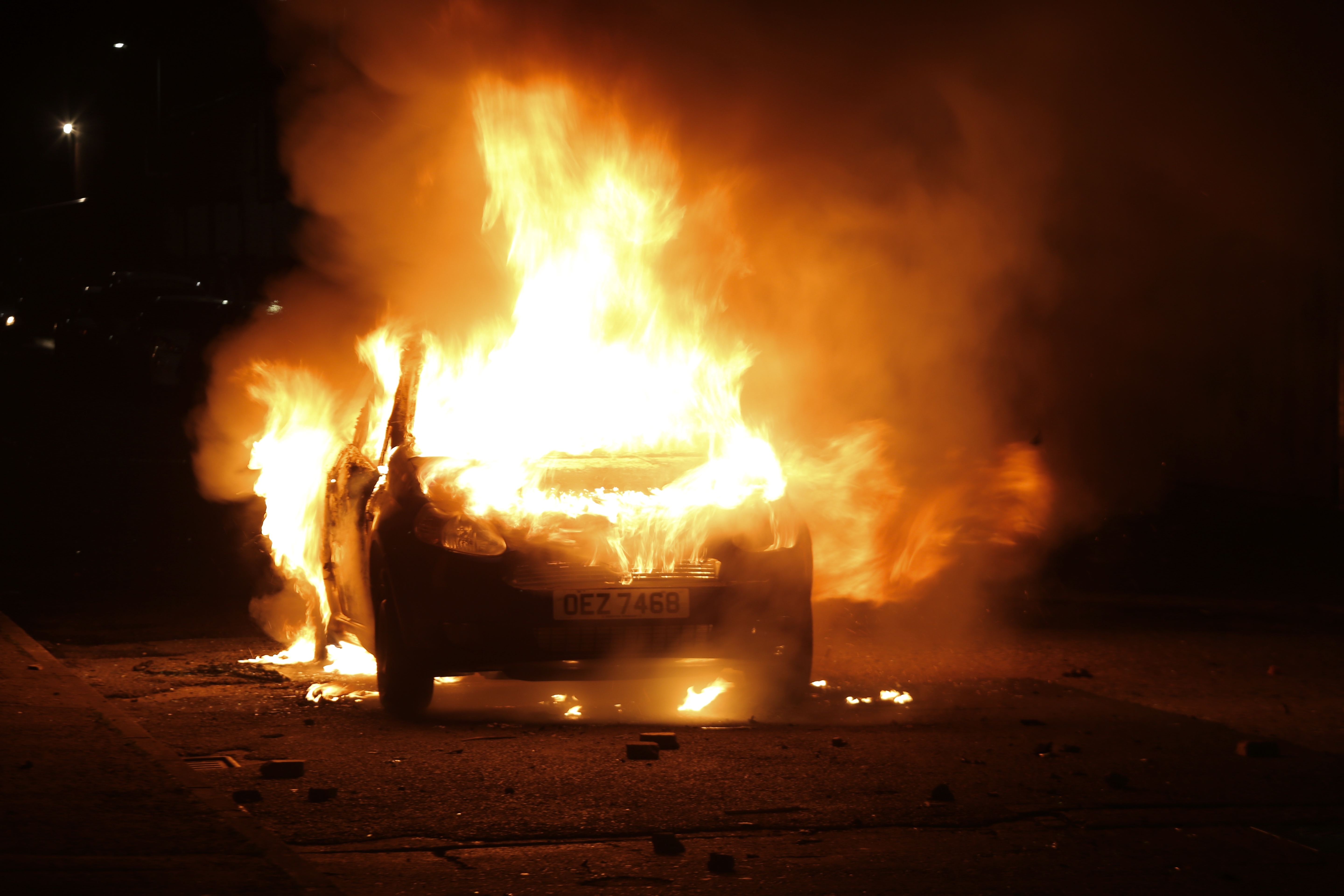 Flames and smoke rise from car set afire during protests as rioters hurled petrol bombs, fireworks and stones at police amid unrest in Belfast, Northern Ireland, on April 9, 2021. (Hasan Esen/Anadolu Agency via Getty Images)
