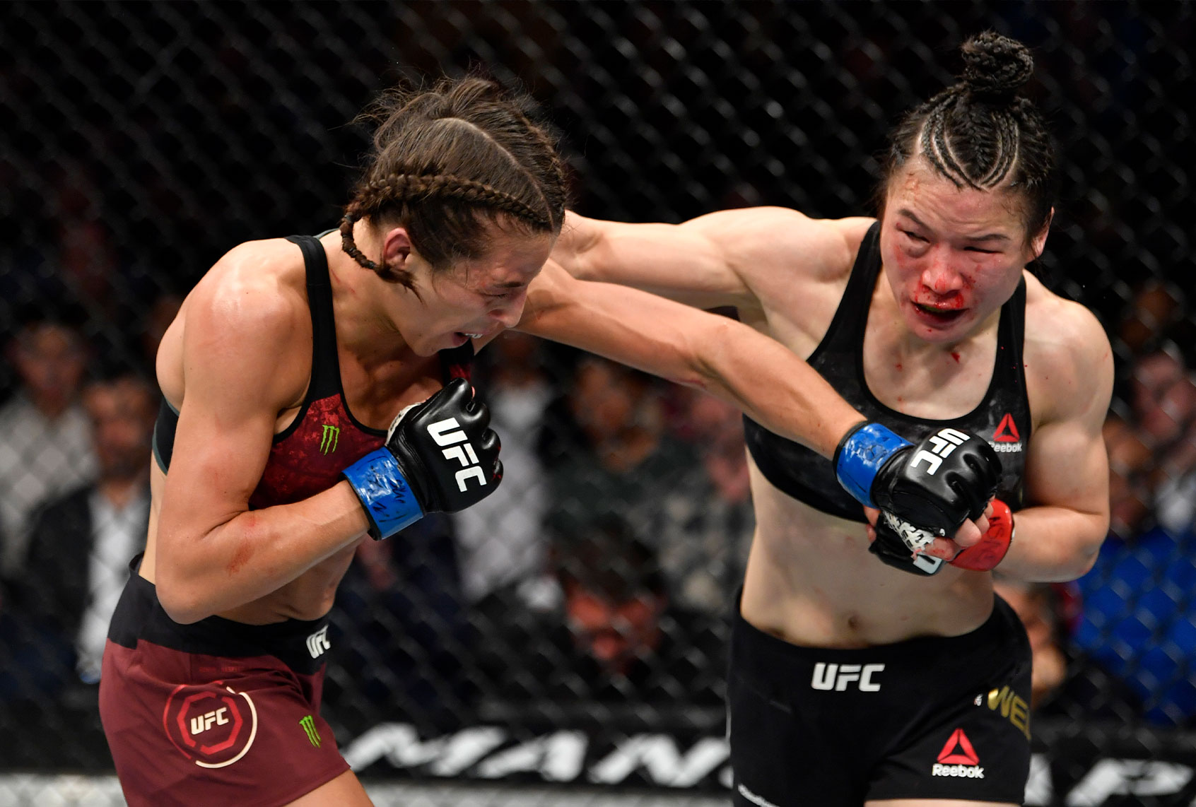 Joanna Jedrzejczyk of Poland punches Zhang Weili of China in their UFC strawweight championship fight (Jeff Bottari/Zuffa LLC)
