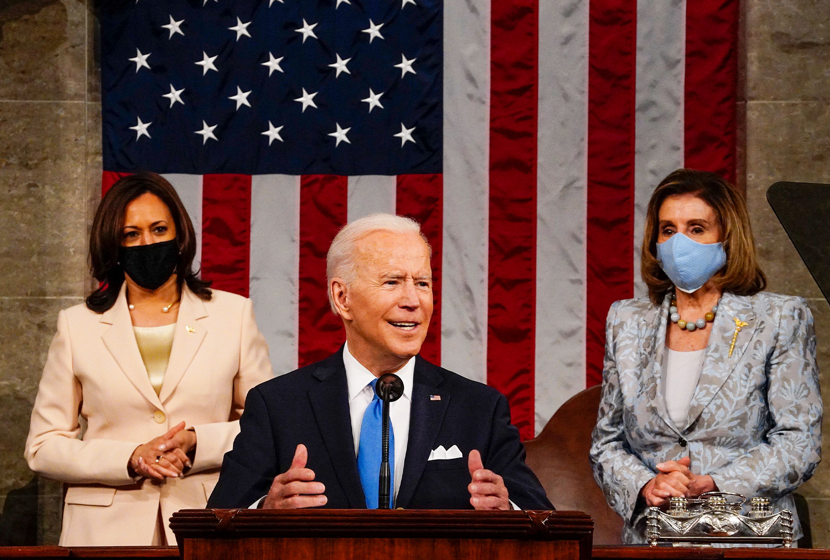 President Joe Biden addresses a joint session of Congress, with Vice President Kamala Harris and House Speaker Nancy Pelosi (D-CA) on the dais behind him on April 28, 2021 in Washington, DC. On the eve of his 100th day in office, Biden spoke about his plan to revive America’s economy and health as it continues to recover from a devastating pandemic. He delivered his speech before 200 invited lawmakers and other government officials instead of the normal 1600 guests because of the ongoing COVID-19 pandemic. (Melina Mara-Pool/Getty Images)