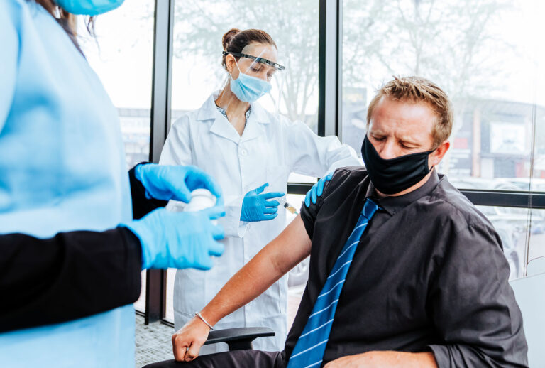 Scared man sitting with his eyes closed during coronavirus vaccination in a hospital (Getty Images)