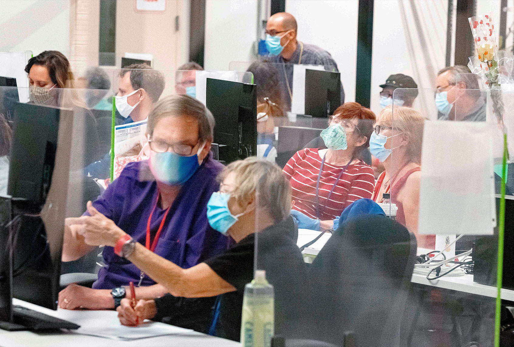 Poll workers count ballots inside the Maricopa County Election Department in Phoenix, Arizona on November 5, 2020 - Former vice president Joe Biden, making his third run at the White House, was tantalizingly close to victory on Thursday as President Donald Trump sought to stave off defeat with scattershot legal challenges and his campaign insisted he would be reelected. (OLIVIER TOURON/AFP via Getty Images)